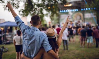 young caucasian couple toasting on a music festival.