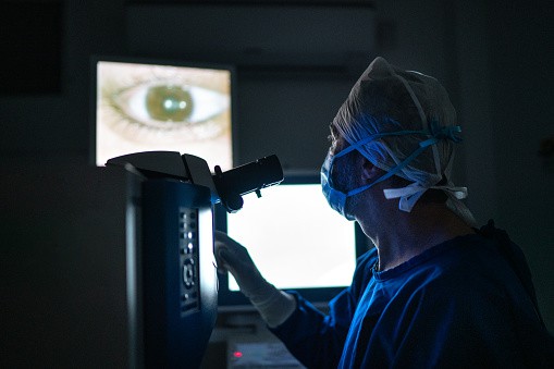 doctor doing an exam or surgery, looking at images in monitor